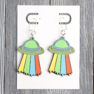 Alien Ship Wood Earrings. These earrings are made with 1/8″ thickness basswood. These earrings are lightweight and hand painted.