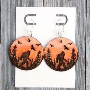 Bigfoot Sunset Scenery Wood Earrings. These earrings are made with 1/8″ thickness basswood. These earrings are lightweight and hand painted.