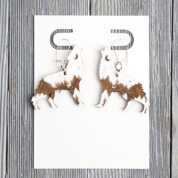 Wolf White Forest Wood Earrings. These earrings are made with 1/8″ thickness basswood. These earrings are lightweight and hand painted.