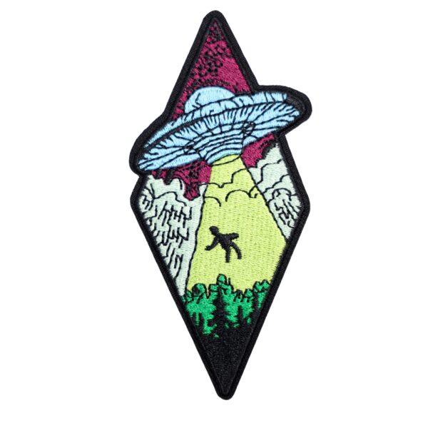 Alien abduction patch with spaceship, light beam, and trees.