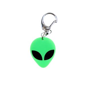 Alien head neon green bag tag with black eyes and black backing.