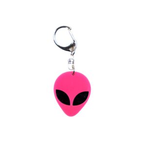 Alien head neon pink bag tag with black eyes and black backing.