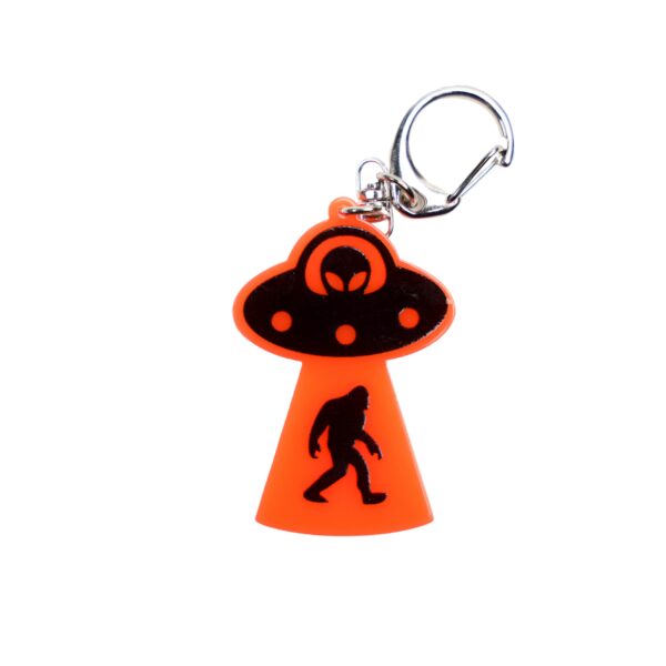 Bigfoot abduction neon orange bag tag with black ship and black backing.