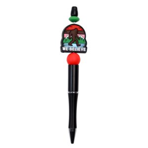 Bigfoot believe writing pen with mountains in red and green with saying we believe.