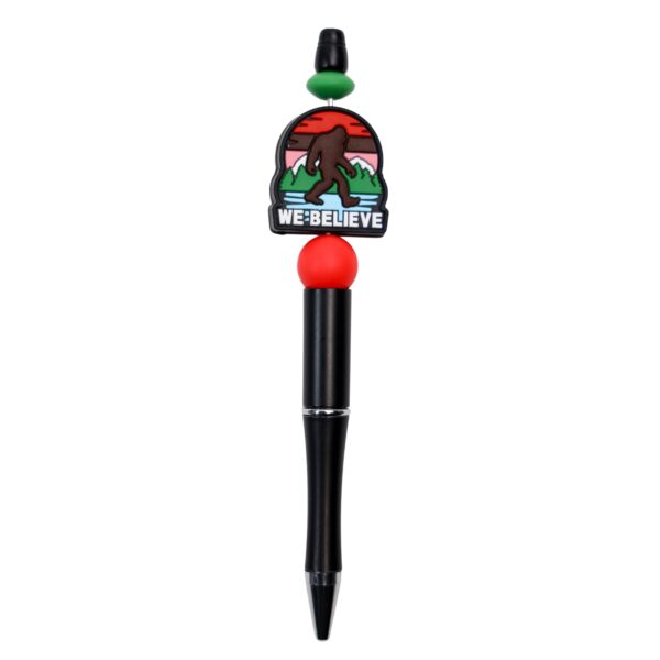 Bigfoot believe writing pen with mountains in red and green with saying we believe.