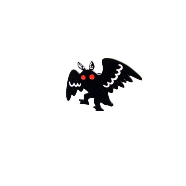 Mothman walking enamel pin with black and white wings and red eyes.