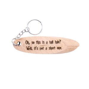 Big Fish Quote Coordinates Driftwood Keychain. "Oh, so this is a tall tale? Well, it's not a short one" front quote and Jackson Lake Island filming location of Big Fish longitude and latitude "32.4483° N 86.3335° W" on the back.