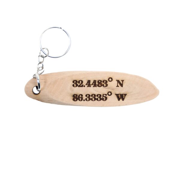 Big Fish Quote Coordinates Driftwood Keychain. "Oh, so this is a tall tale? Well, it's not a short one" front quote and Jackson Lake Island filming location of Big Fish longitude and latitude "32.4483° N 86.3335° W" on the back.