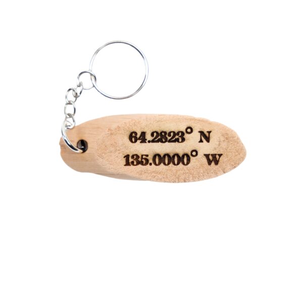 Call Of The Wild Driftwood Keychain. “A great dog will guide your heart.” front quote and Yukon filming location of Cal Of The Wild longitude and latitude “64.2823° N 135.0000° W” on the back.