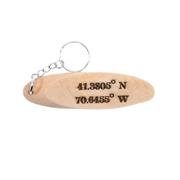 Jaws Driftwood Keychain. “You're gonna need a bigger boat.” front quote and Martha's Vineyard, MA filming location of Jaws longitude and latitude “41.3805° N, 70.6455° W” on the back.